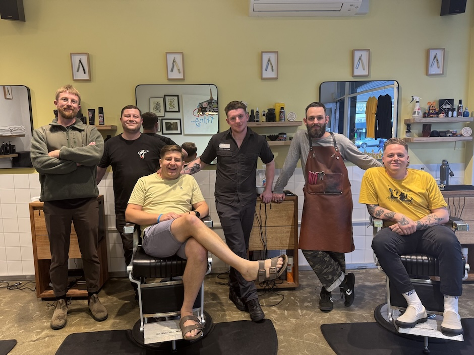 A group of people smiling together in a workshop